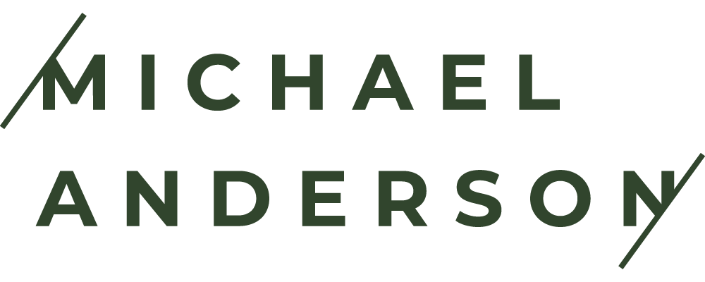 Logo with dark green letters spelling 'Michae Anders'.