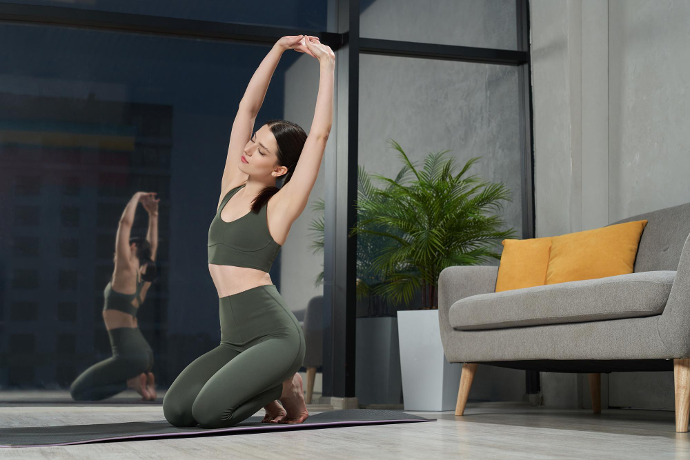 Woman stretching in workout clothes indoors.