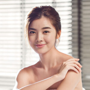A smiling woman with smooth skin and a natural look.